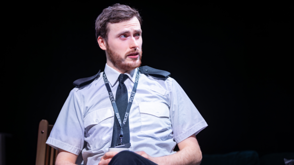 Ross Stephenson playing the part of a police officer